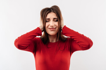 Image of young stressed woman grabbing her head. Problems, surprise, fear, fobia concept. Studio shot, white background