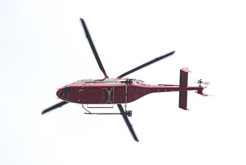 Red helicopter isolated in the sky