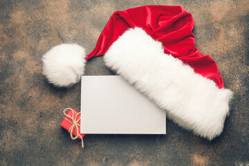 Blank paper and Santa hat on grunge background