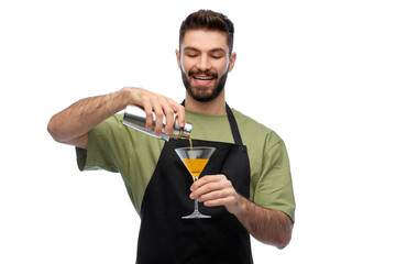 alcohol drinks, people and job concept - happy smiling barman in black apron with shaker and glass...