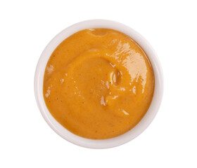 Mustard sauce in bowl, isolated on white background. Honey mustard salad dressing. Top view.