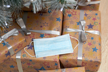 A face mask is placed on Christmas gifts as a symbol of safety