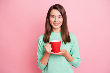 Photo of relax cheerful brunette straight hair girl hold cup wear pastel sweater isolated on pink color background