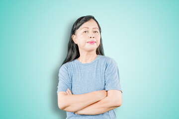 Fototapeta premium Senior woman folded hands with haughty expression