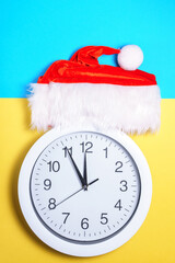Red Santa hat, clock. Christmas and New Year. copy space. vertical photo
