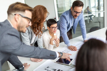 Business coworkers discussing new ideas and brainstorming in a modern office