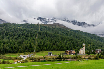 Fototapeta na wymiar Panoramic view of Solda, South Tyrol, Italy, its parish church on the lake, with the Ortler mountains in the background