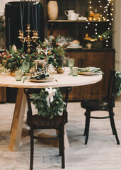 Festive kitchen in Christmas decorations. Christmas dining room. Beautiful New Year decorated classic home interior. 