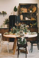 Festive kitchen in Christmas decorations. Christmas dining room. Beautiful New Year decorated classic home interior. 