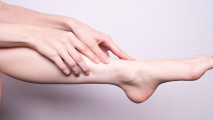 Fototapeta na wymiar massage of leg muscles with hands, leg pain