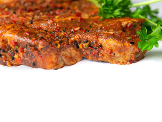 Raw uncooked pork belly slices marinated with Korean style souse and herbs and fresh coriander leafs on a white surface, Meat industry product, Close up