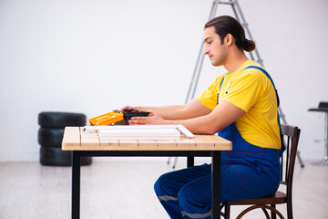 Young male carpenter working indoors