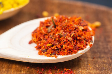 dry spices in a wooden spoon close-up on a vintage background. selective focus