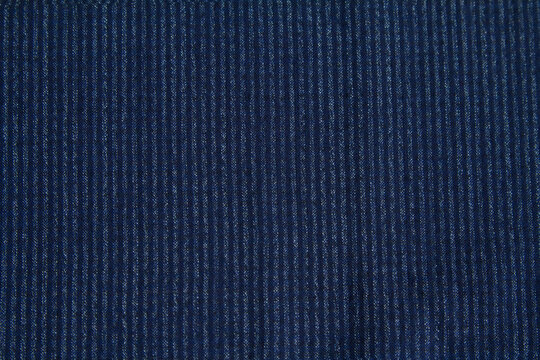 Background of textured wool fabric in a small blue stripe for autumn and winter wardrobe. Horizontal orientation