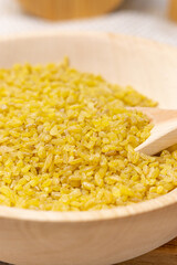 Vegetarian cuisine dry bulgur for cooking in the bowl. Concept of agriculture. Vertical photo