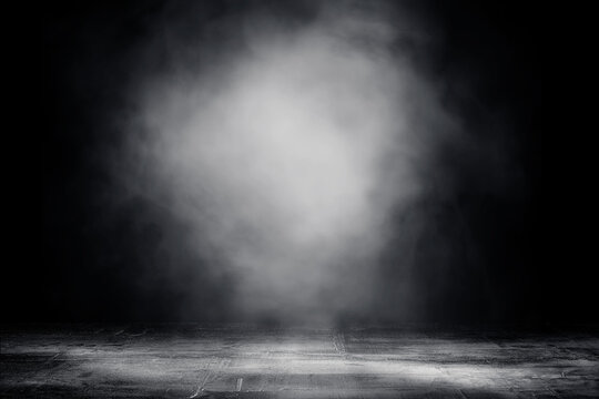 Empty space of Studio dark room concrete floor grunge texture background with spot lighting and fog or mist.