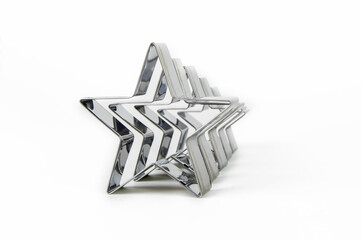 Metal forms for cookies in the shape of a star on a white background in a row.