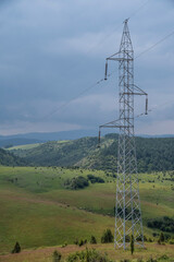 High voltage transmission lines and towers runing trough green lawn and forest on mountain Uvac, Zlatar with blue sky and meanders in the background.

Meanders of river Uvac, mountain Zlatar, Serbia