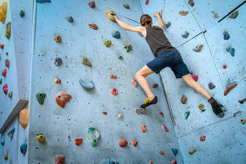 Teenage Boy Training On Climbing Wall