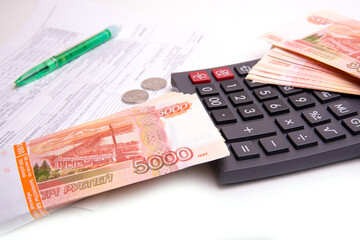 Banknotes, Russian banknotes, calculator, isolated on a white background, panoramic banner format, close-up, space for text