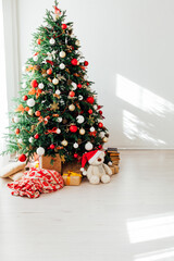 Interior white room with Christmas tree window with new year gifts