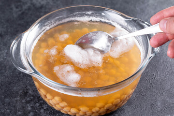 Chickpeas cooked in a pot of water and boils