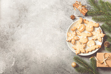 Fototapeta na wymiar christmas background. christmas composition with fir branches, gifts, sweets, cookies, cinnamon on a light concrete background