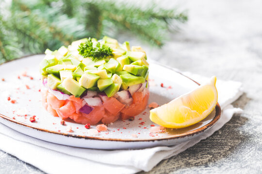 Raw salmon, avocado and purple onion salad. salmon tartar. appetizer for New Year's or Christmas table