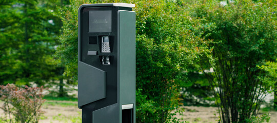 Charging station for electric cars near bushes. Caring for environment. Eco-friendly.