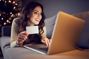 Fototapeta premium Woman shopping online from home during christmas
