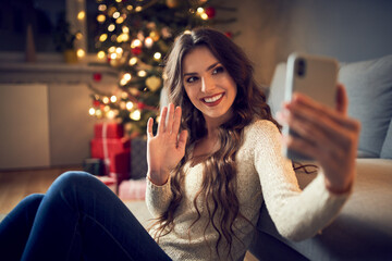 Woman spending Christmas on quarantine video calling family