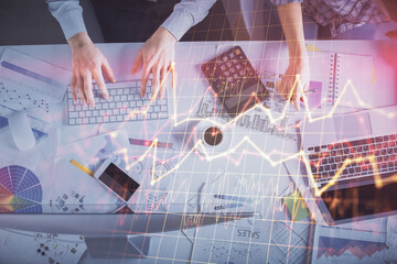 Double exposure of man and woman working together and financial chart hologram drawing. market analysis concept. Computer background. Top View.