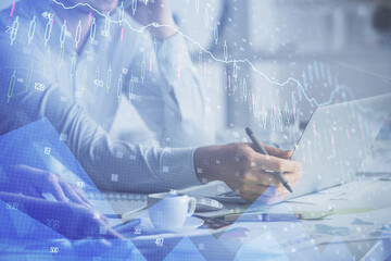 Double exposure of man and woman working together and financial graph hologram. Business concept. Computer background.
