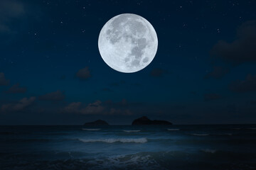 Fototapeta na wymiar Full moon over sea in the dark night.