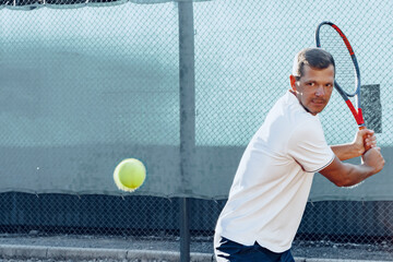 Proffesional tennis player beats off a ball during match