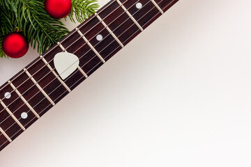 Christmas music. Flat lay composition with guitar and fir tree branches