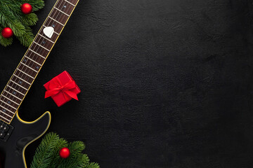 Christmas music. Flat lay composition with guitar and fir tree branches