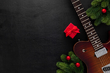Christmas music. Flat lay composition with guitar and fir tree branches