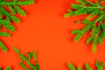 Christmas composition. Christmas frame made of fir branches on a red background