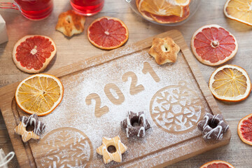 Festive table setting for Valentine's Day with plate, gift boxes, fork, knife and hearts on a wooden table. 