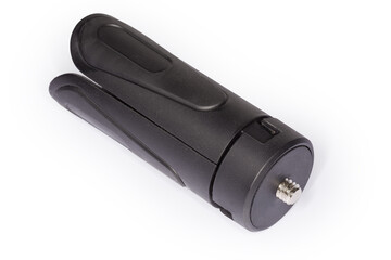 Folded tabletop mini tripod on a white background