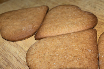 Heart shaped gingerbread cookies fresh from the oven, undecorated, preparing for Christmas at home