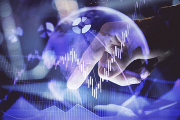 Multi exposure of man's hands holding and using a phone and financial chart drawing. Market analysis concept.