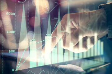 Multi exposure of man's hands holding and using a phone and financial chart drawing. Market analysis concept.