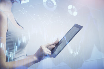 Double exposure of forex chart sketch hologram and woman holding and using a mobile device. Financial market concept.
