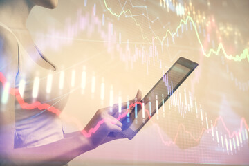 Double exposure of forex chart sketch hologram and woman holding and using a mobile device. Financial market concept.
