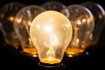 Close-up many light bulb on black background