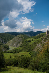 Fototapeta premium Scenic canyon view of meanders on the river Uvac, on the Zlatar Mountain,with beautiful sky in the background.Uvac is a special nature reserve in Serbia with endangered bird species Griffon Vulture.