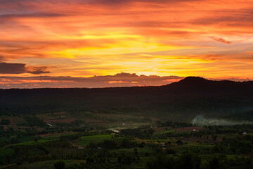 orange twilight sunset sky over green  mountains scene