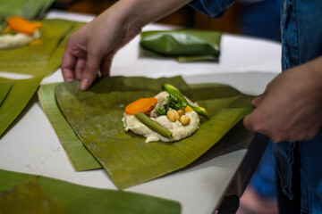 Wrapping tamales Latin American dish.